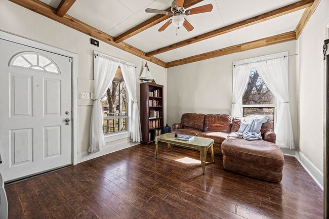 Entrance foyer with a ceiling fan, beam ceiling, baseboards, and hardwood / wood-style flooring | Image 5