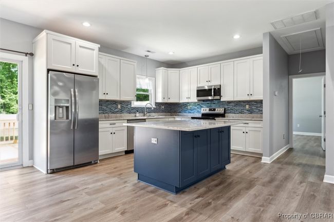 Kitchen featuring appliances with stainless steel finishes, plenty of natural light, decorative backsplash, and recessed lighting | Image 12