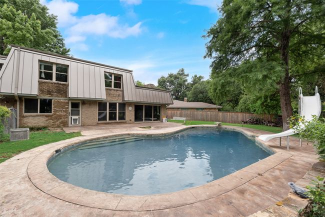 View of pool featuring a water slide and a patio | Image 32