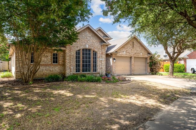Traditional-style home featuring brick siding, a garage, and driveway | Image 5