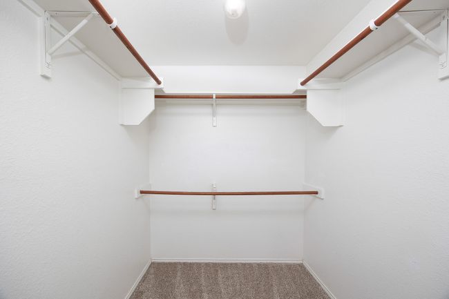 Walk in closet featuring carpet flooring | Image 24