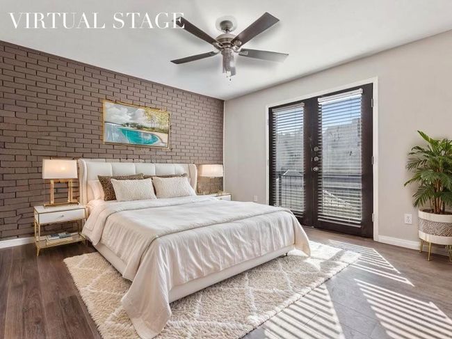 Bedroom featuring wood finished floors, access to exterior, a ceiling fan, baseboards, and brick wall | Image 32
