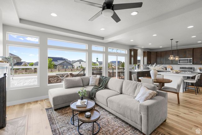 Living room featuring recessed lighting, light wood finished floors, a ceiling fan, and baseboards | Image 4