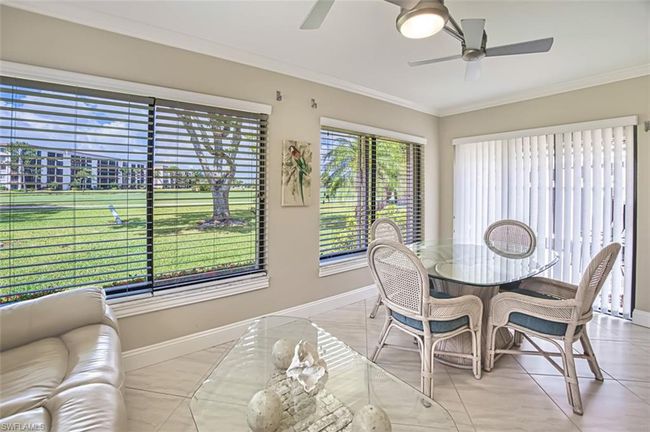 Dining area with baseboards, ornamental molding, a ceiling fan, and light tile patterned flooring | Image 15