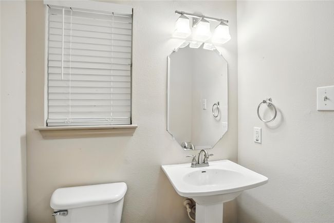 Bathroom featuring toilet and a sink | Image 31