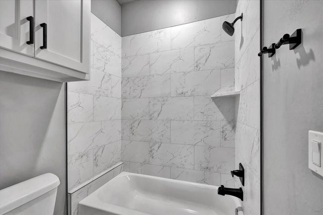 Bathroom featuring toilet and shower combination | Image 43