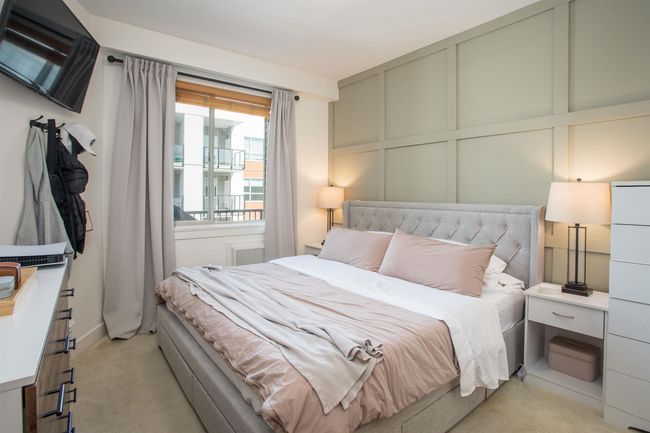 Bedroom with light colored carpet and a decorative wall | Image 16