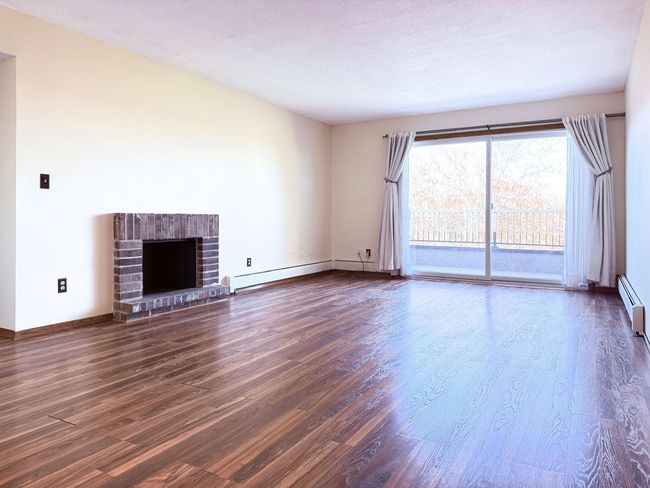 Living room has wood burning fireplace. | Image 6