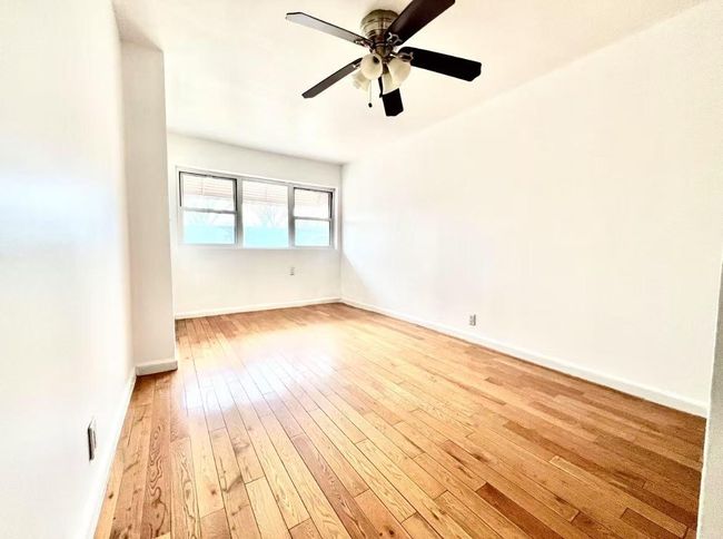 Unfurnished room with light wood-type flooring and ceiling fan | Image 5