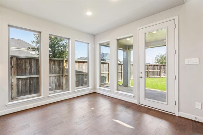 Located just off the kitchen, this cozy nook is bathed in natural light and overlooks the backyard | Image 15