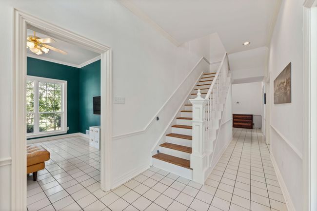 Stairs with crown molding, tile flooring | Image 6