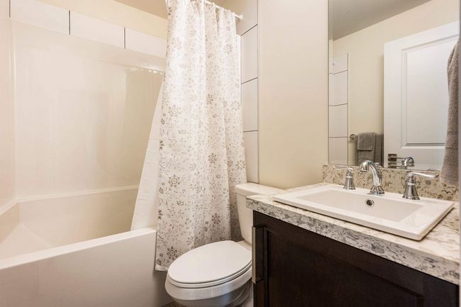 Bathroom featuring shower / bath combo, toilet, and vanity | Image 35
