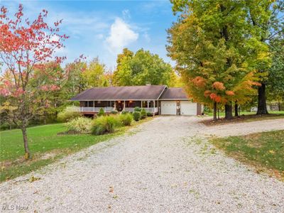 View of front of property with a garage and a front lawn | Image 2