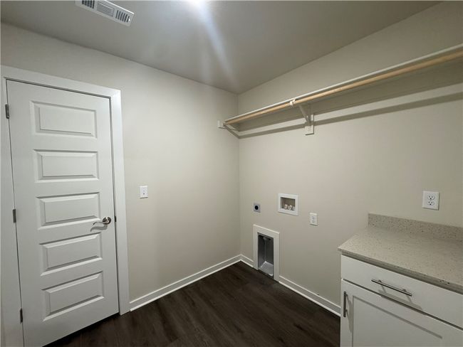 Large laundry room with storage and rod to hang clothes | Image 20