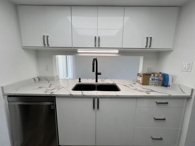 Kitchen featuring dishwasher, white cabinetry, and light stone counters | Image 13