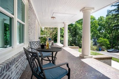 Front porch sits above road and terraced yard | Image 2