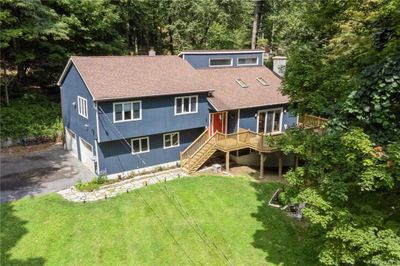 Rear view of house featuring a garage and a yard | Image 2