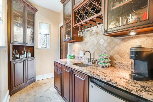 Prep room off the kitchen that has a sink, mini fridge, and wine rack | Image 10
