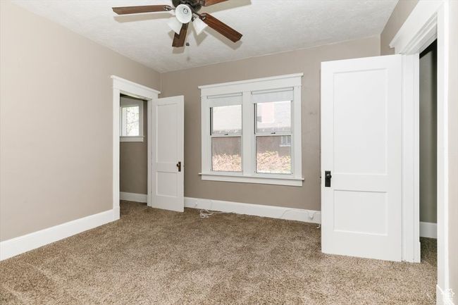 Bathroom featuring toilet, vanity, crown molding, and shower combination | Image 16