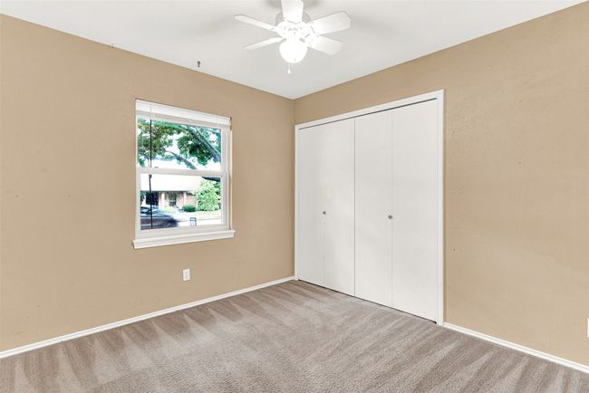 Unfurnished bedroom featuring carpet floors, a closet, and a ceiling fan | Image 16