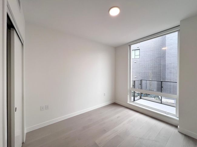 Unfurnished bedroom with wood finished floors and a closet | Image 7