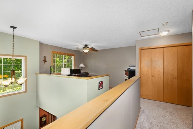 Half wall continues the open concept upstairs | Image 16