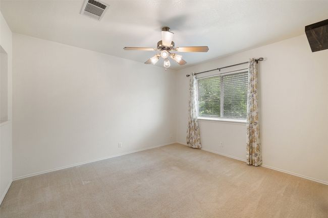 Empty room with baseboards, ceiling fan, carpet, and visible vents | Image 31