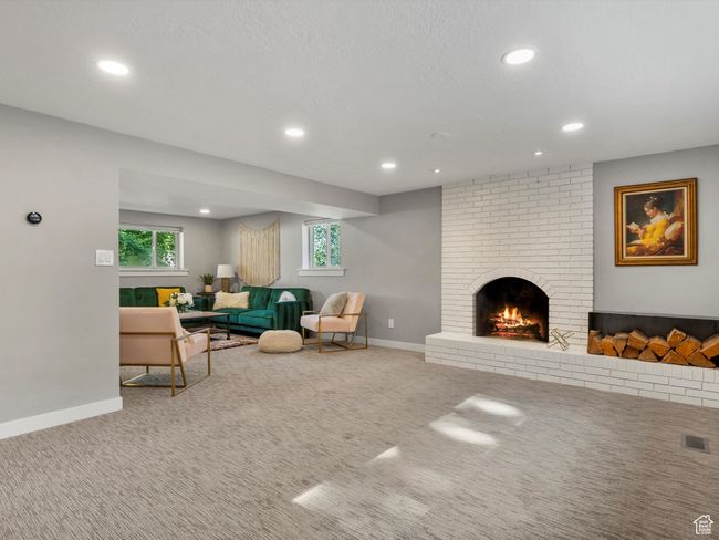 Living area with recessed lighting, carpet floors, and a fireplace | Image 31