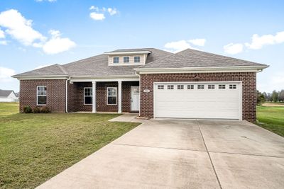 Home is one level for easy living, and features an oversized two car garage and concrete driveway so there's plenty of space for parking. | Image 3