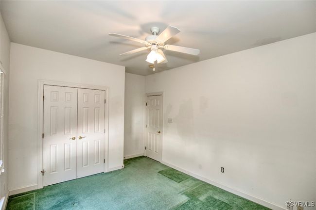 Unfurnished bedroom featuring baseboards, carpet floors, a closet, and ceiling fan | Image 26