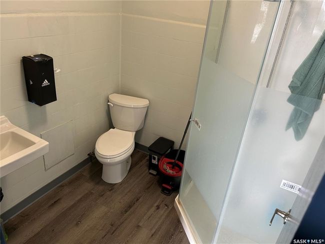 Full bath featuring tile walls, wood finished floors, toilet, and a shower stall | Image 18