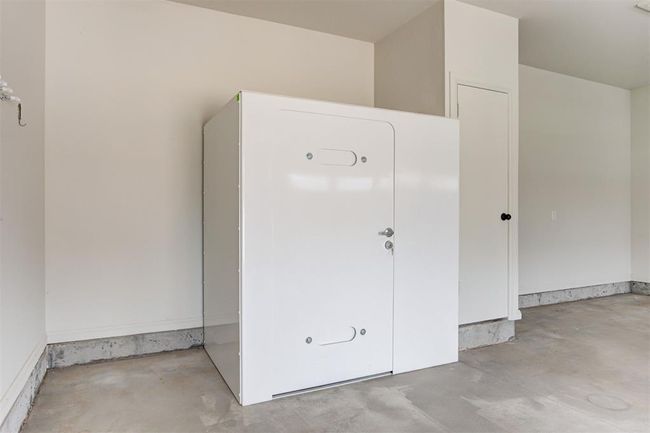 Above ground storm shelter in the garage. | Image 29