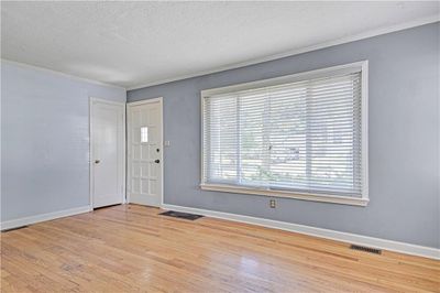 Entrance foyer featuring ornamental molding, a textured ceiling, and hardwood / wood-style flooring | Image 2