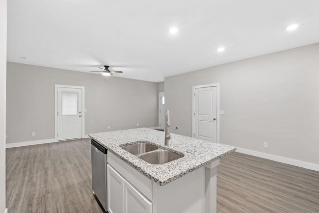 Kitchen with a sink, dishwasher, ceiling fan, light wood-type flooring, and recessed lighting | Image 15
