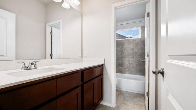 Full bath featuring vanity, tile patterned floors, and bathing tub / shower combination | Image 19
