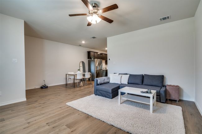 Living room featuring a ceiling fan, light wood-type flooring, and recessed lighting | Image 7