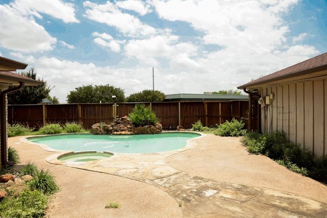 View of pool featuring a fenced backyard, a patio, and a pool with connected hot tub | Image 25