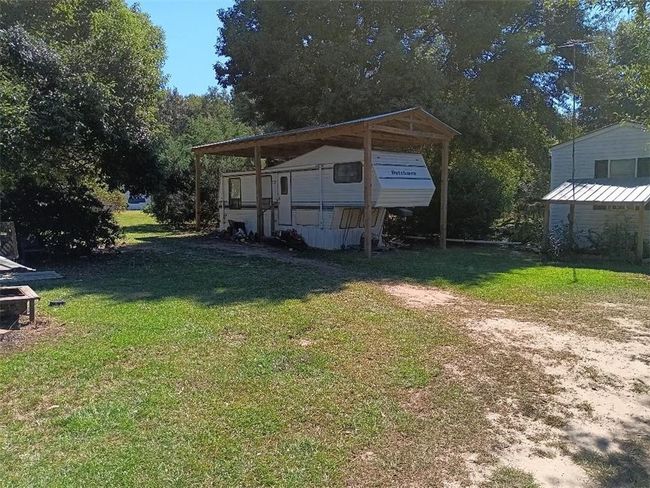 View of yard with a carport and driveway | Image 9
