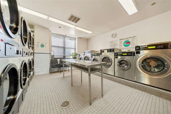 Communal laundry room featuring stacked washer / dryer, tile patterned floors, and independent washer and dryer | Image 20