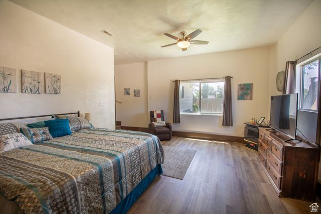 Bedroom featuring wood finished floors and ceiling fan | Image 14
