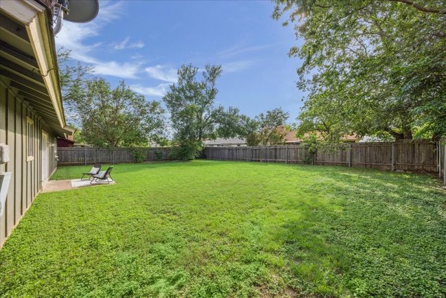 Fenced backyard with a patio area | Image 27