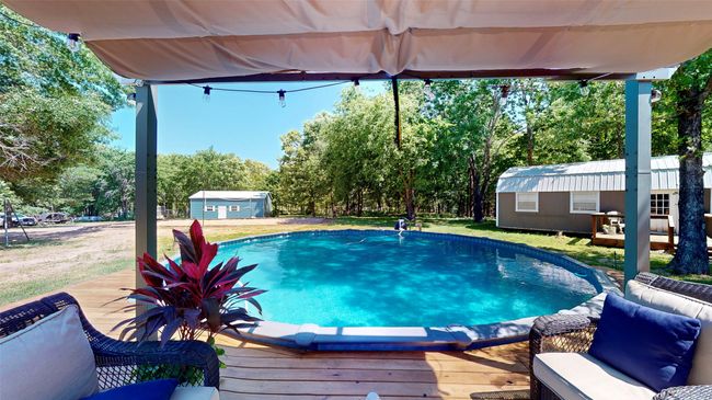 View of pool featuring an outdoor structure and a deck | Image 26