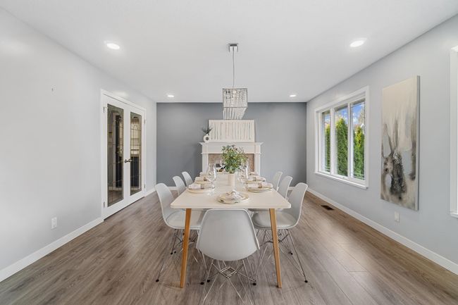 Dining room featuring recessed lighting, a premium fireplace, baseboards, and wood finished floors | Image 15