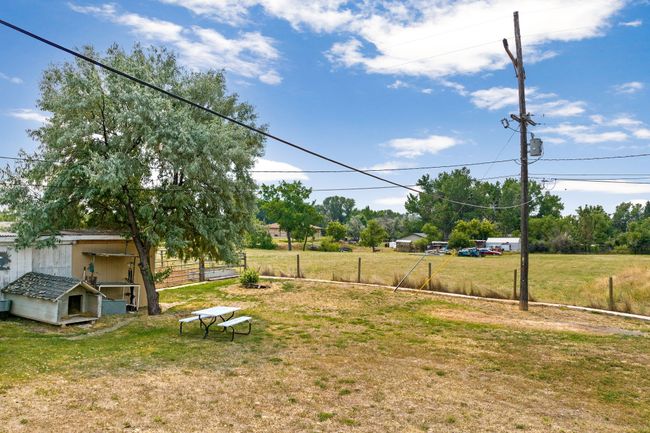 View of yard featuring an outbuilding and fence | Image 29