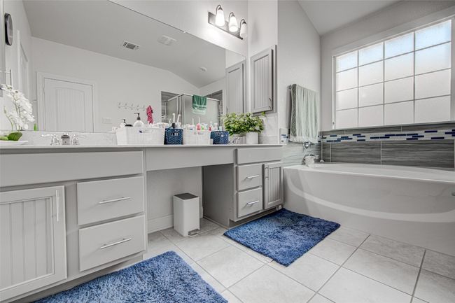 Master Bathroom Blurred Window with Solar Shade installed. Dual Sinks. Medicine Cabinets on each Sink. Standing Shower & Tub shower | Image 25