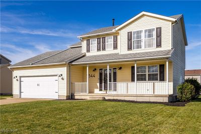 View of front of home with a front yard, a porch, and a garage | Image 2