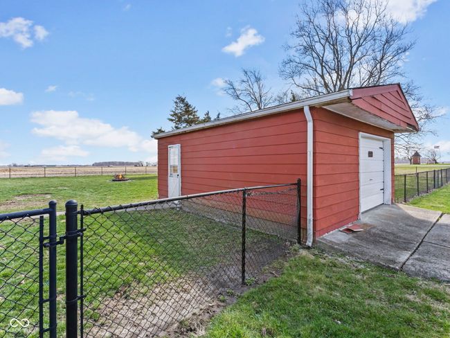 view of outdoor structure with an outbuilding, driveway, fence, and a rural view | Image 34