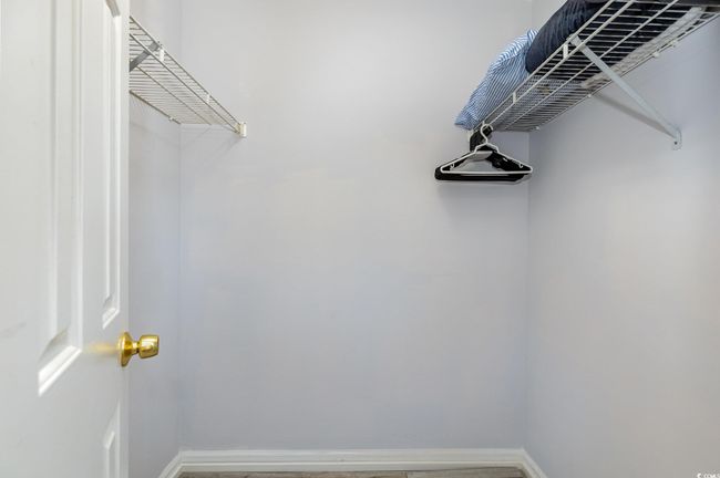 Spare room featuring baseboards, stacked washing maching and dryer, and light wood-style floors | Image 25