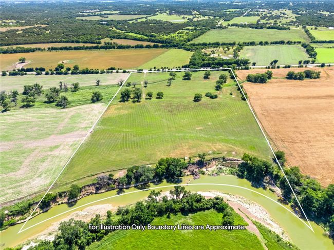 Aerial view of sparsely populated area featuring property parcel outlined and farmland | Image 4