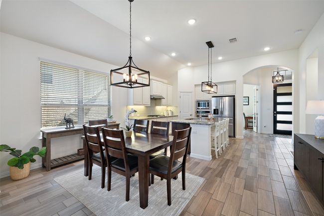 Dining area offers effortless flow from kitchen to living. | Image 12